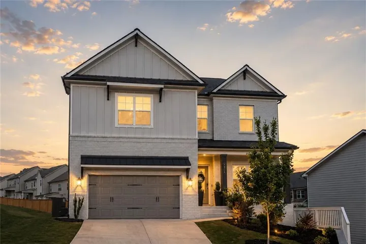 Modern traditional exterior featuring board and batten siding and light-toned brick