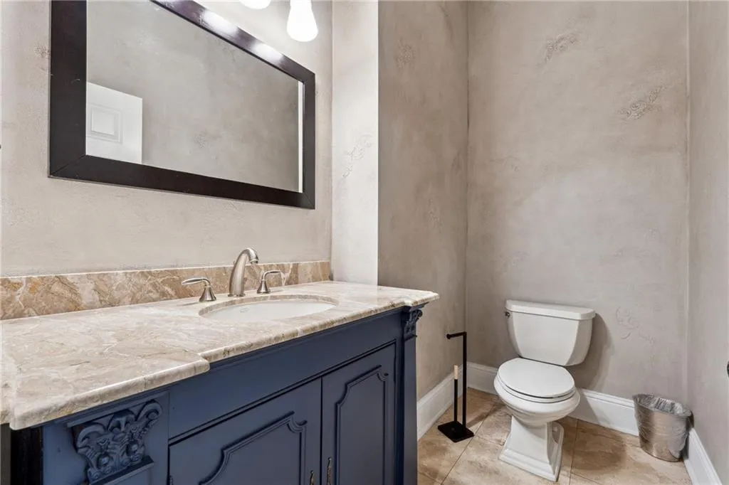 Bathroom featuring vanity, tile patterned floors, and toilet