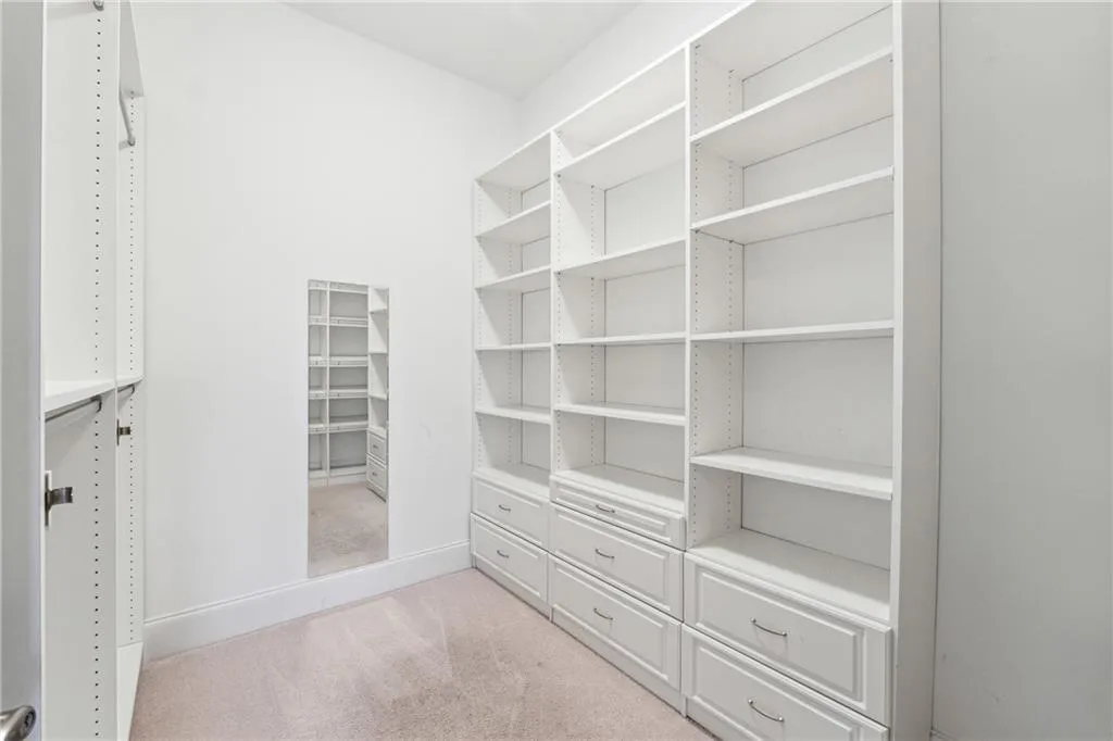 Spacious closet with light carpet