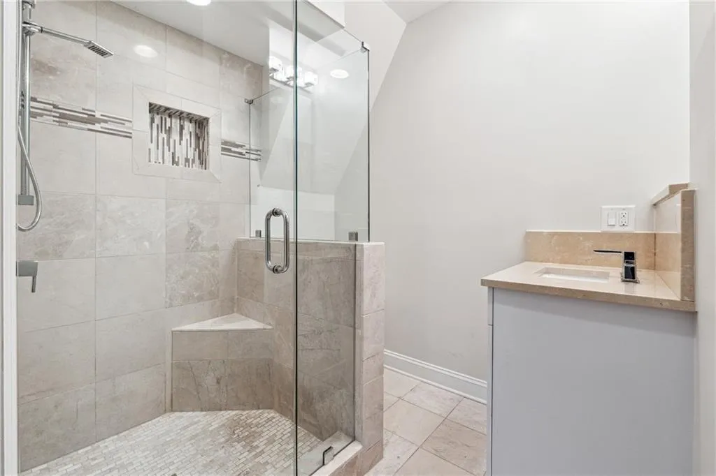 Bathroom with vanity, tile patterned floors, and walk in shower