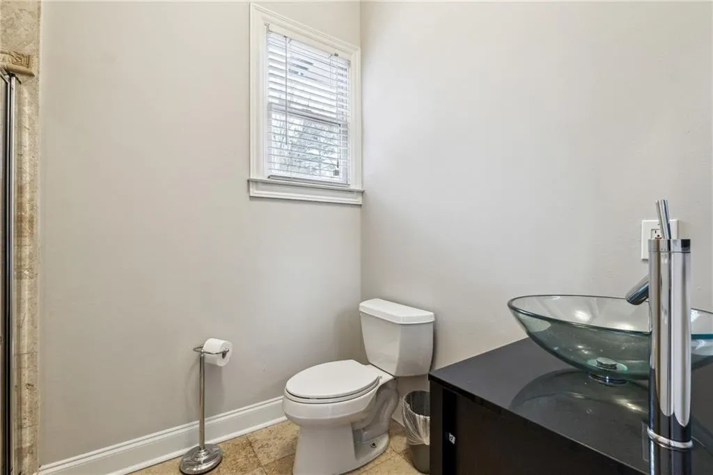 Bathroom featuring tile patterned floors, vanity, and toilet