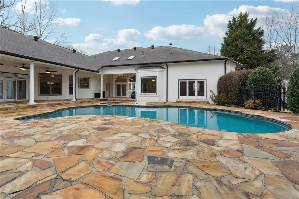 View of pool with a patio area, french doors, and ceiling fan
