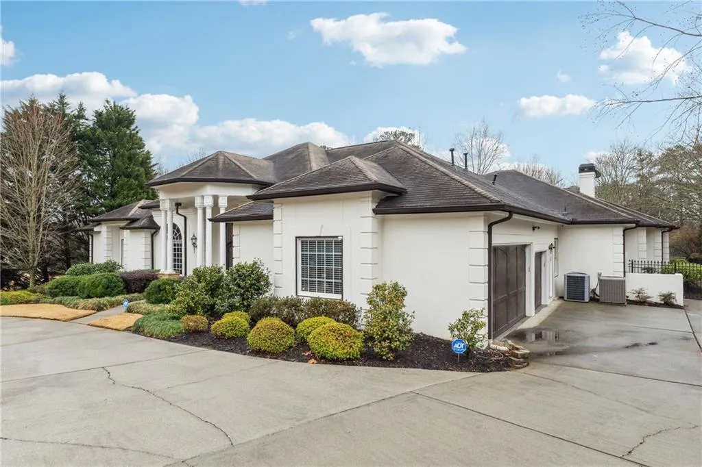 View of side of home featuring a garage and central AC
