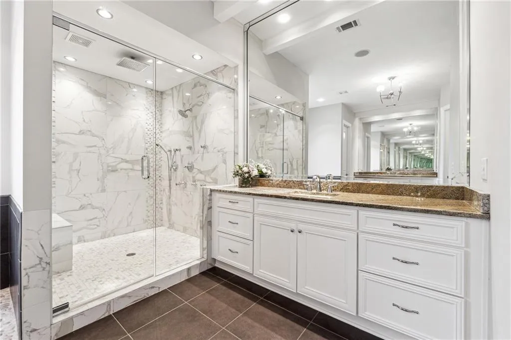 Bathroom with a chandelier, tile patterned floors, an enclosed shower, and vanity