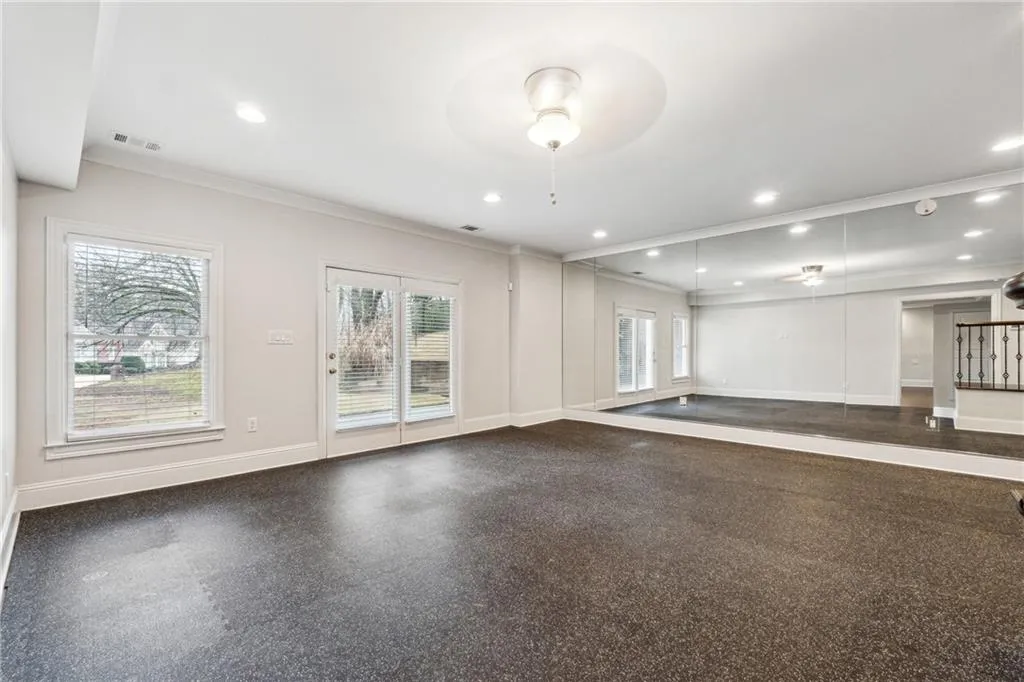 Empty room with crown molding and ceiling fan