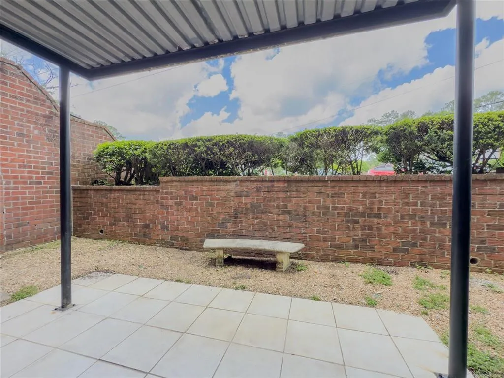 View of patio featuring fence