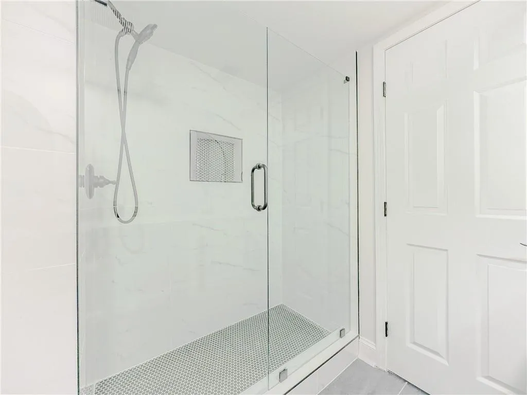 Full bathroom featuring a marble finish shower