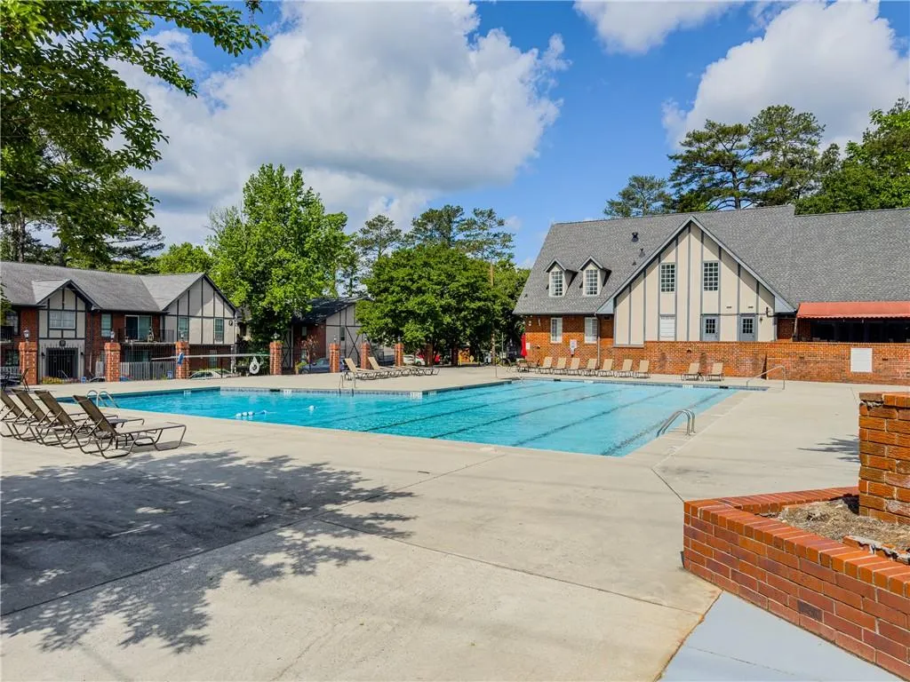 Community pool with fence and a patio area