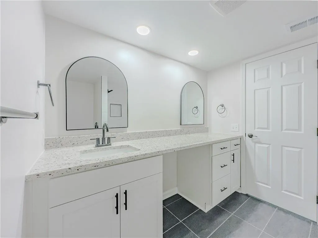 Bathroom with vanity, visible vents, and tile patterned floors