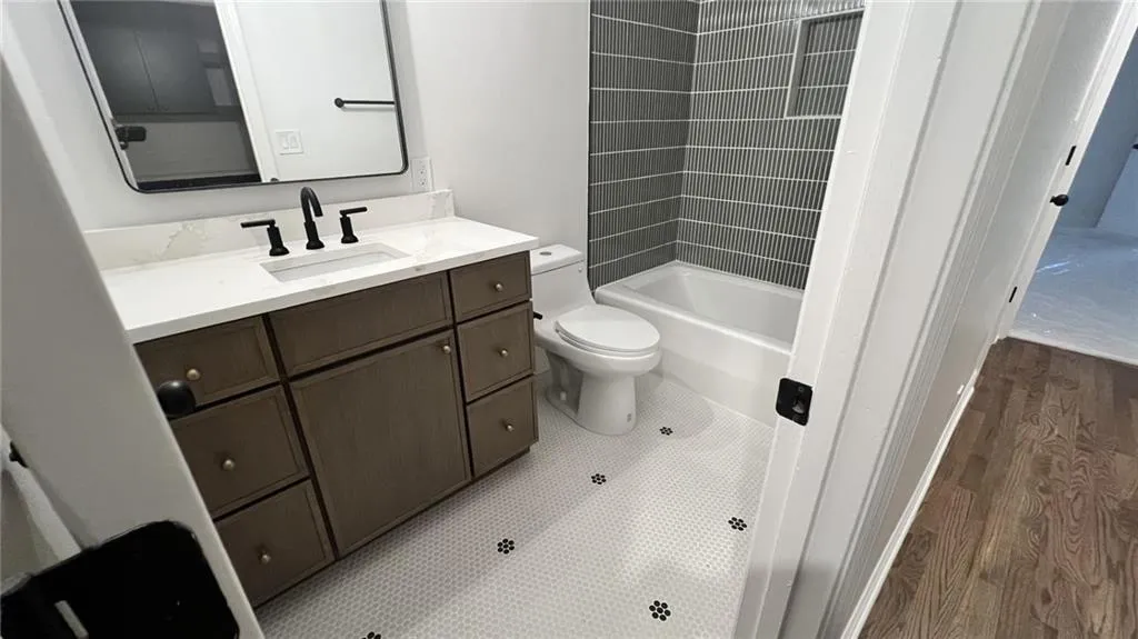 Bathroom featuring vanity and shower / tub combination