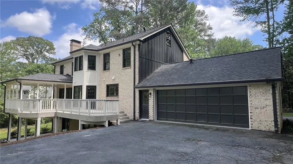 View of front facade featuring brick siding and asphalt driveway