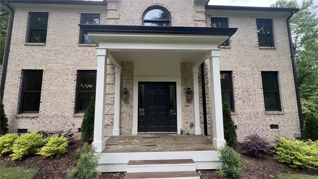 View of exterior entry featuring brick siding and crawl space