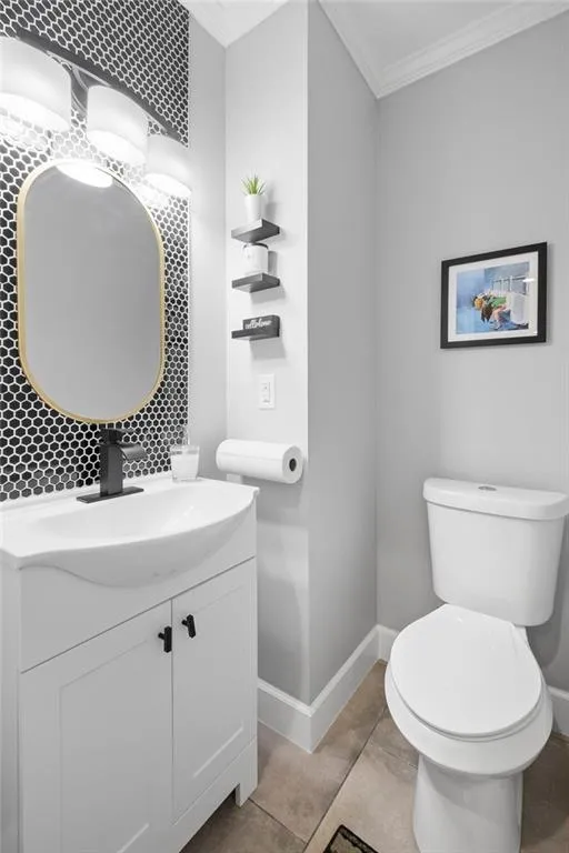 Bathroom with crown molding and vanity
