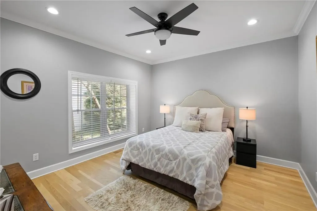 Bedroom with ornamental molding, light wood-style flooring, recessed lighting, and a ceiling fan