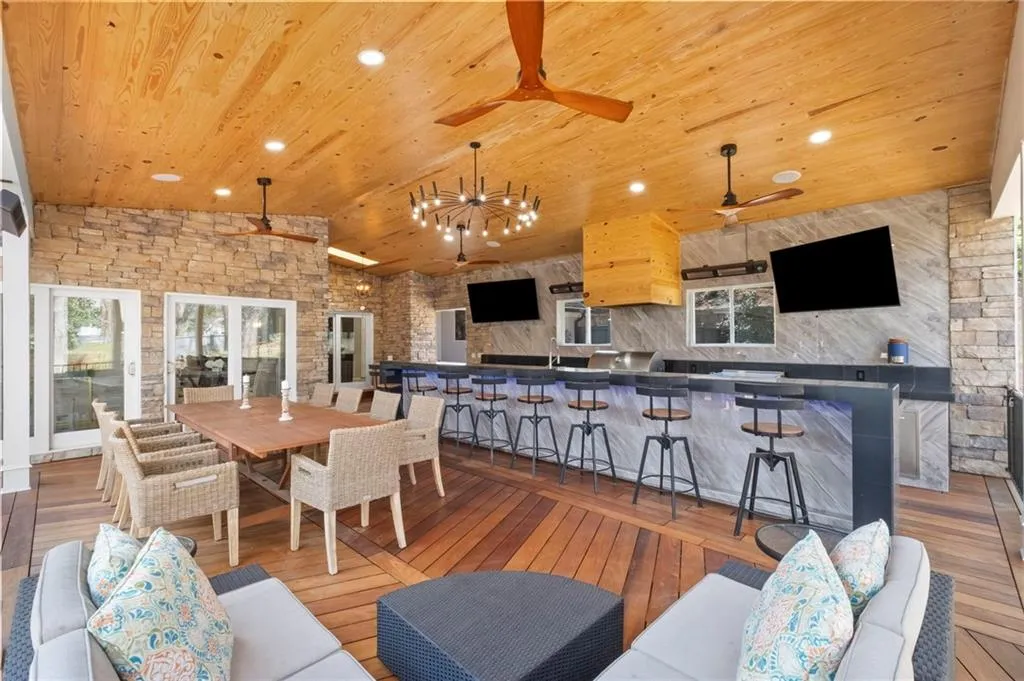 Living area featuring light wood-type flooring, a vaulted wooden ceiling, recessed lighting, and ceiling fan