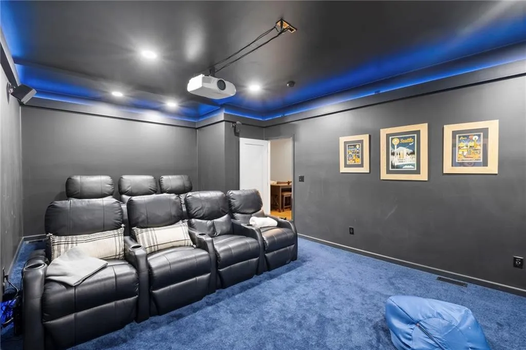 Carpeted cinema room featuring baseboards