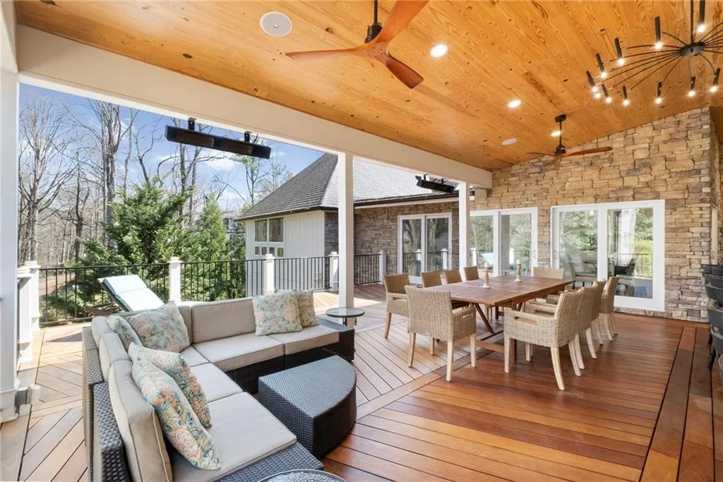 Wooden deck featuring outdoor lounge area and ceiling fan