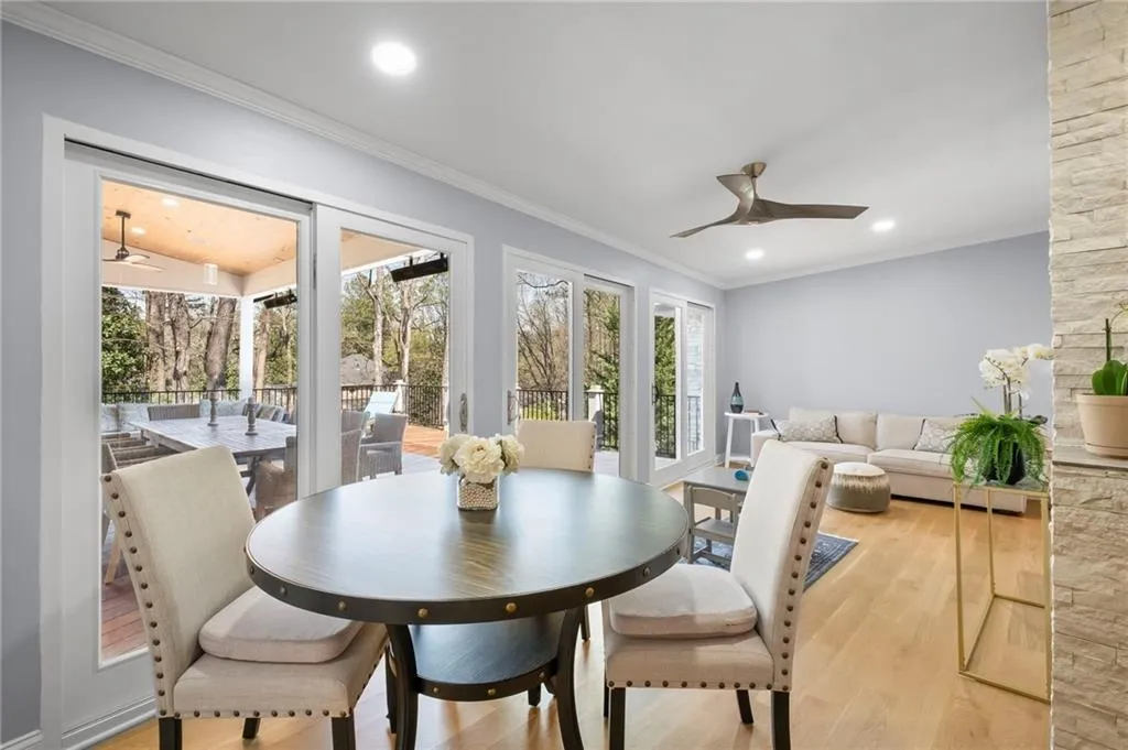 Dining area featuring ceiling fan, ornamental molding, light wood finished floors, and recessed lighting