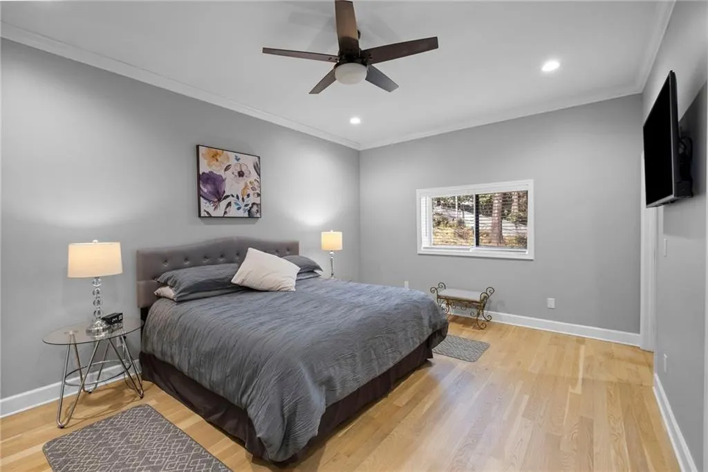 Bedroom featuring ornamental molding, light wood-style flooring, recessed lighting, and ceiling fan