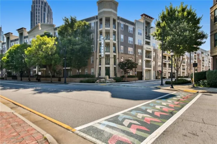 Multi-story residential building featuring balconies and a prominent corner turret