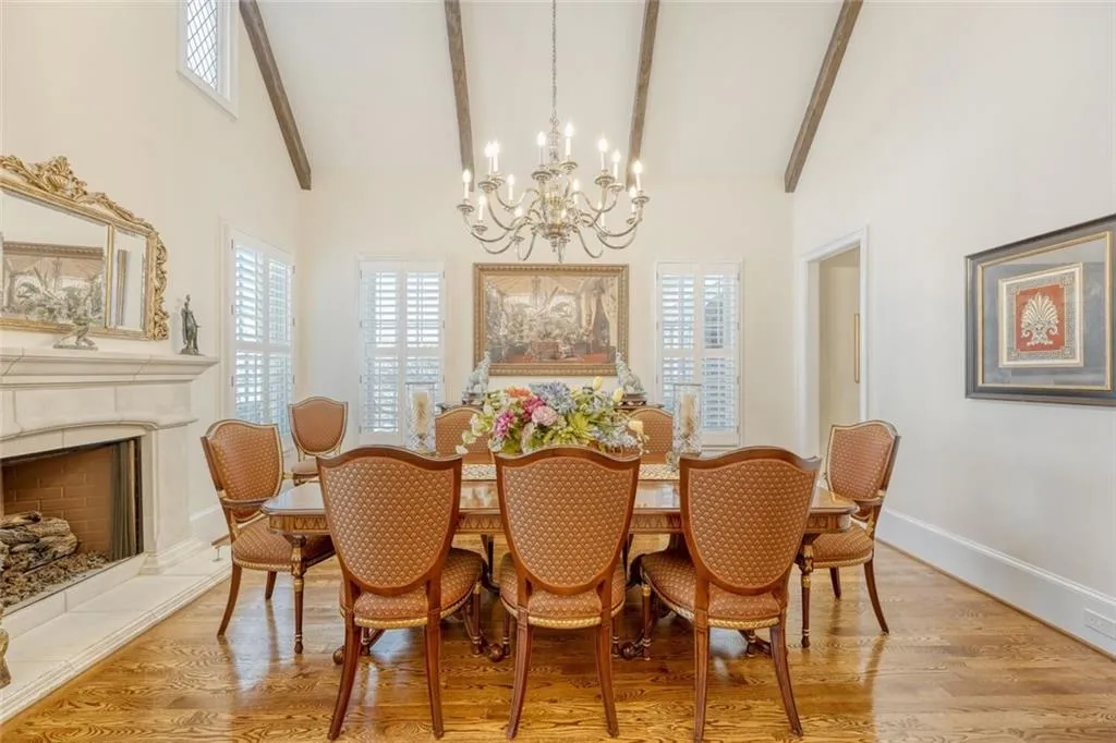 Vaulted ceiling and fireplace adorn dining room.