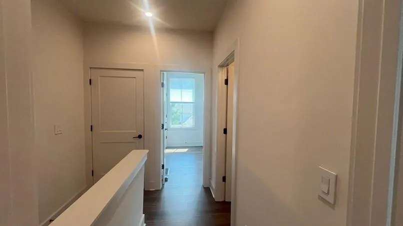 Hall with dark wood-type flooring