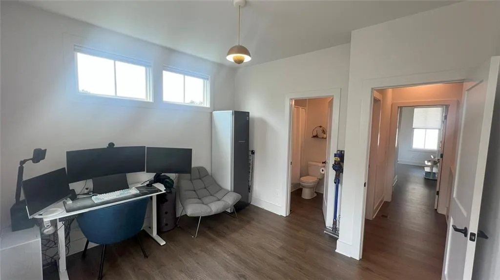 Office area with dark wood finished floors and baseboards