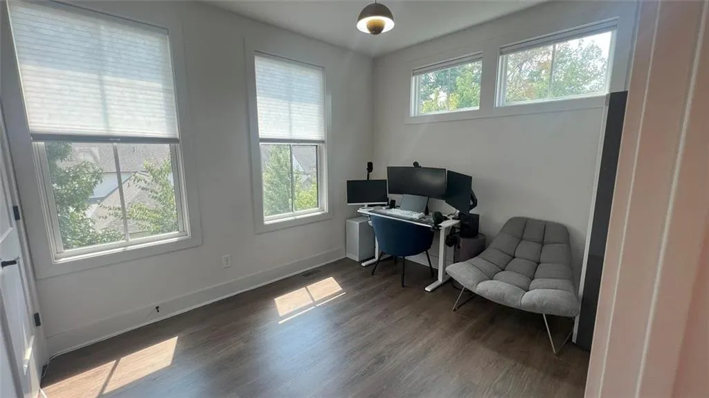 Office space with baseboards and dark wood finished floors
