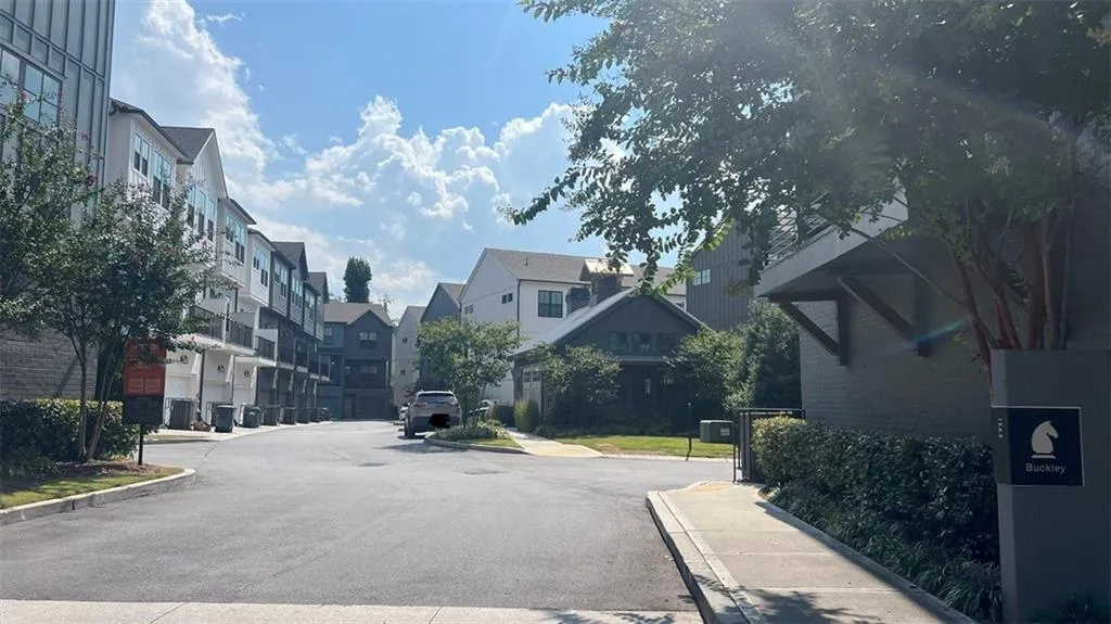 View of asphalt road featuring curbs