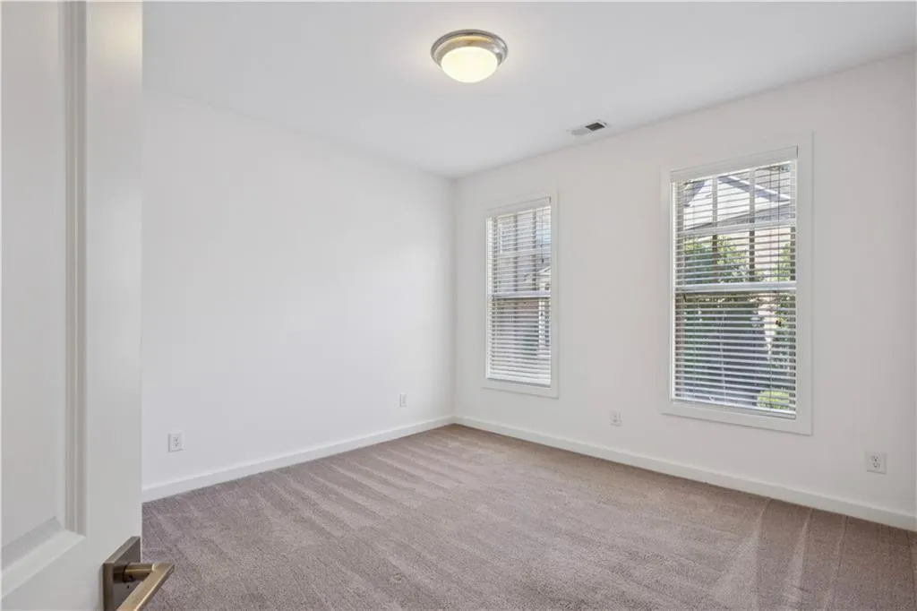 Unfurnished room with light carpet