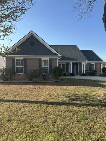 Single story home with a front lawn, a porch, and a shingled roof