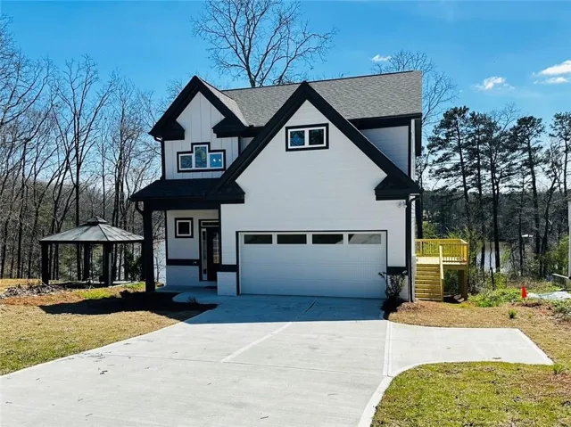 Modern black and white exterior with a prominent front-facing garage