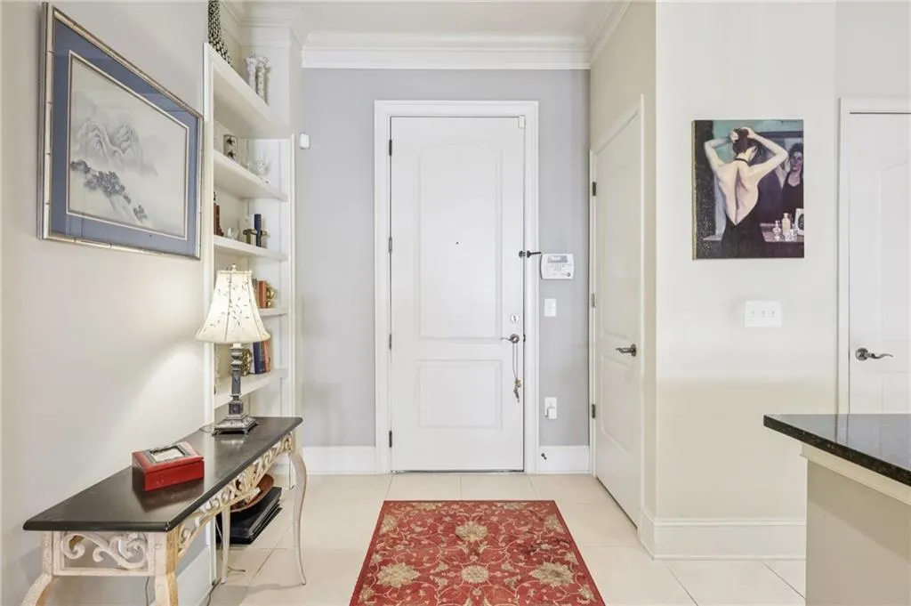 Foyer with ornamental molding and light tile patterned floors