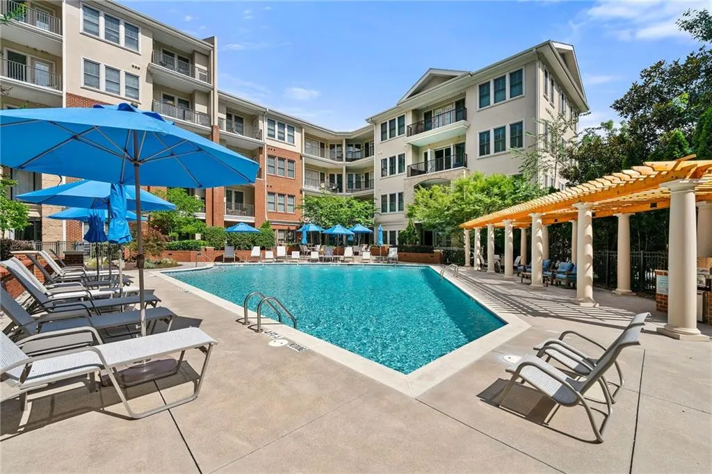 Community pool with a pergola and a patio area Community pool with a pergola and a patio area