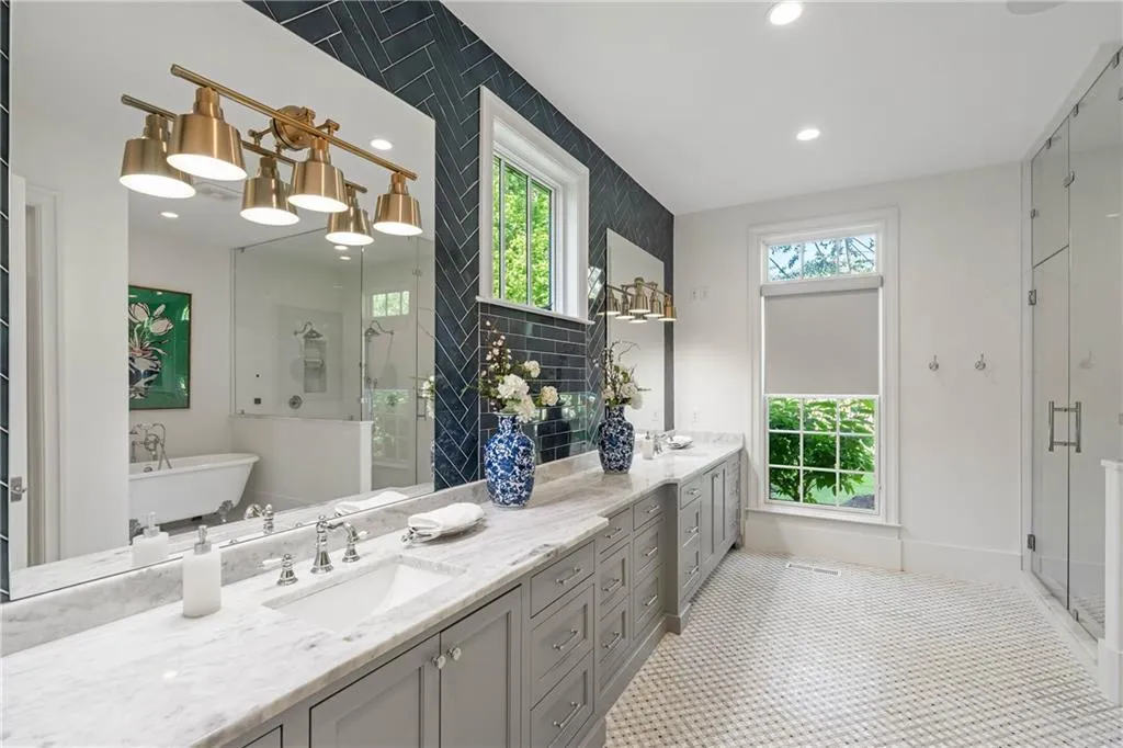 Primary bath with dual vanities and marble countertops
