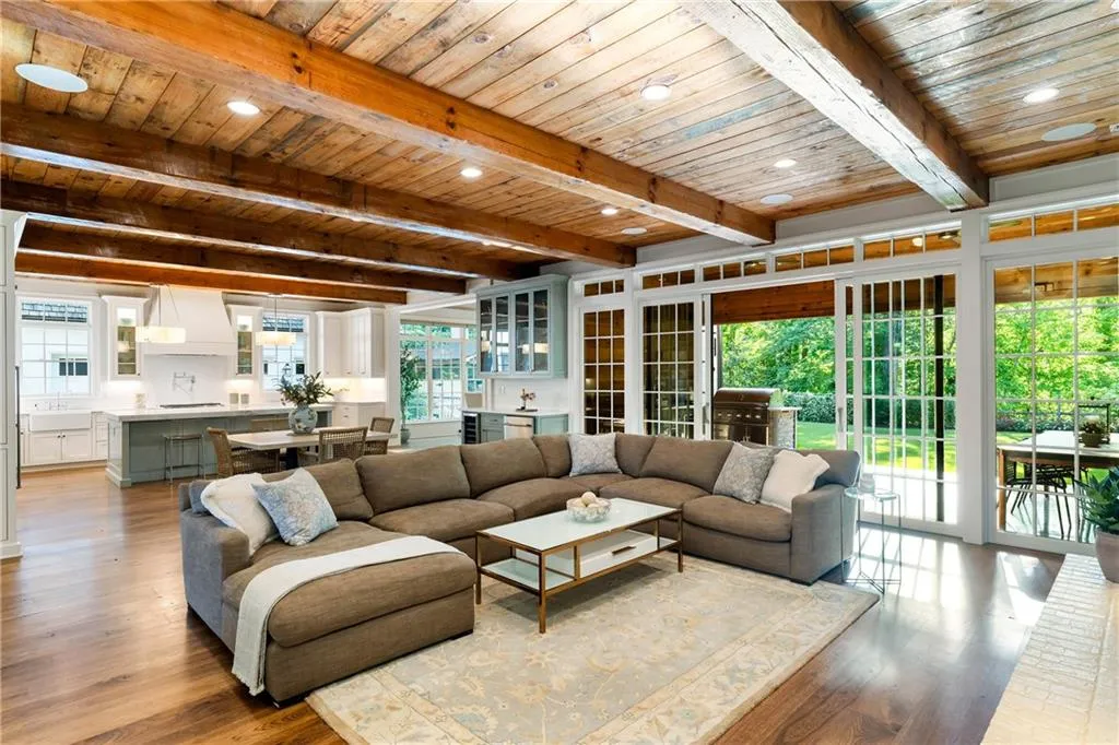 Pine ceilings, hickory hardwood flooring and wood beams are showcased throughout the home