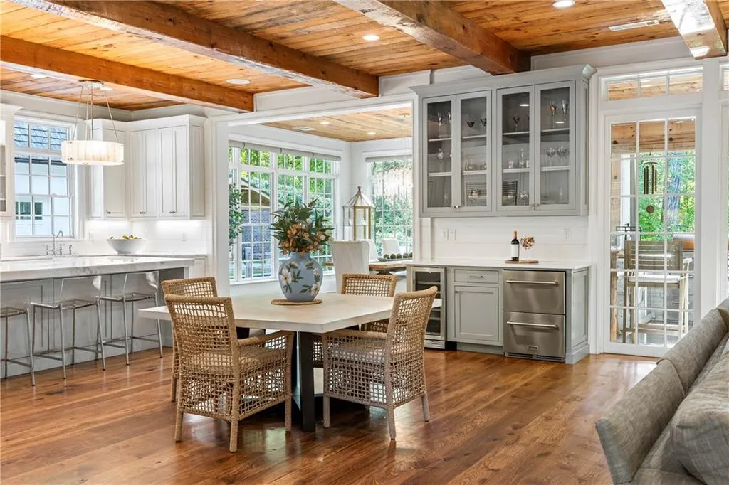 Custom bar with wine cooler, beverage drawers, storage and cabinets with glass casing