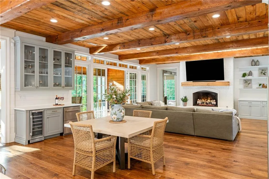 Open concept fireside great room with sliding doors to covered patio and outdoor kitchen, fenced backyard, heated saltwater pool and spa and pavilion with wood burning fireplace