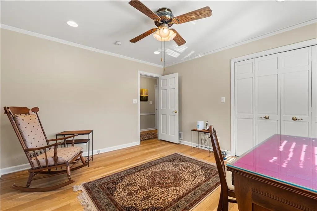 Home office featuring crown molding, light wood-style flooring, recessed lighting, and a ceiling fan