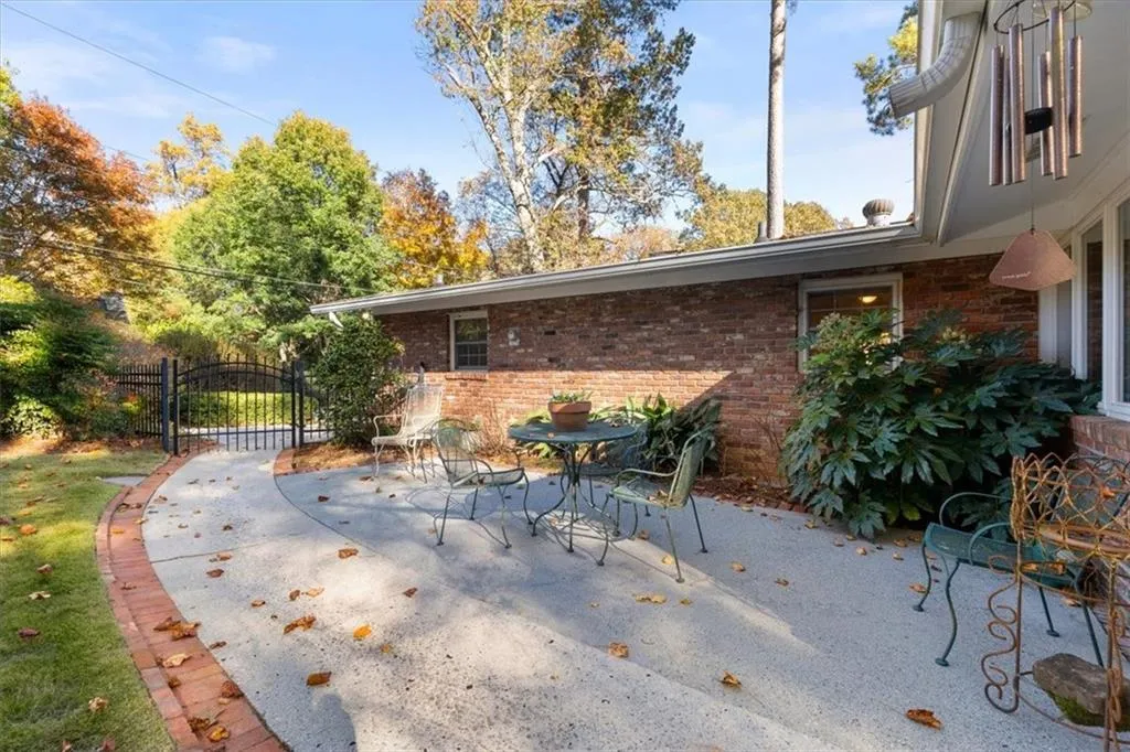View of patio / terrace featuring a gate and outdoor dining area
