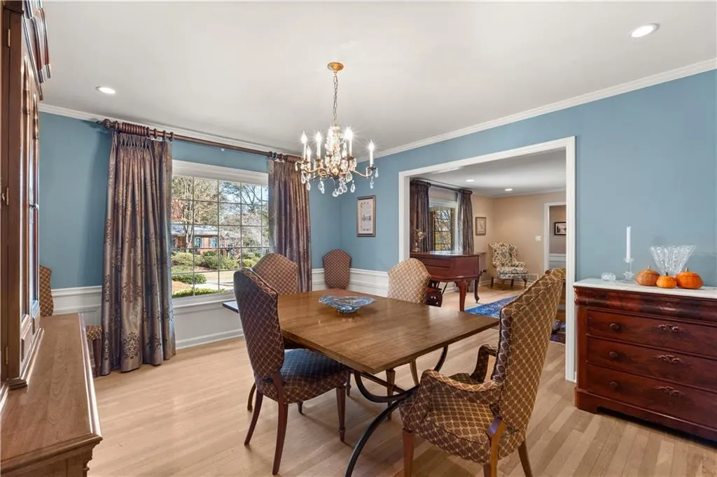 Dining room featuring recessed lighting, crown molding, a chandelier, and light wood finished floors