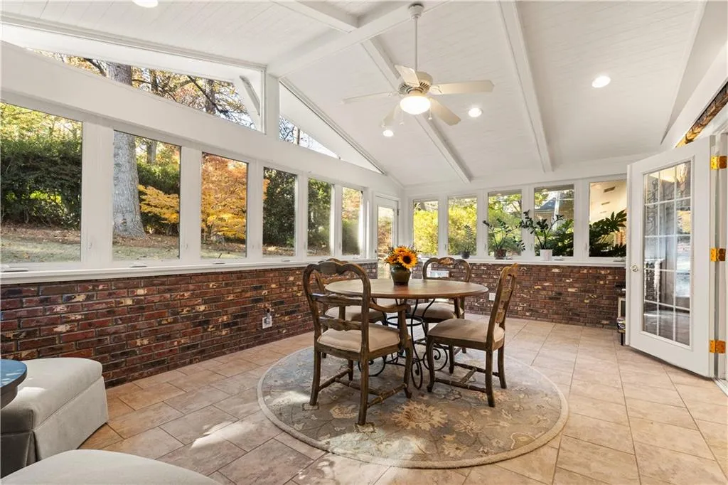 Sunroom with brick wall and recessed lighting