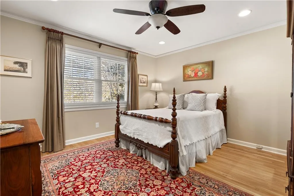 Bedroom featuring light wood-type flooring, ornamental molding, a ceiling fan, and recessed lighting