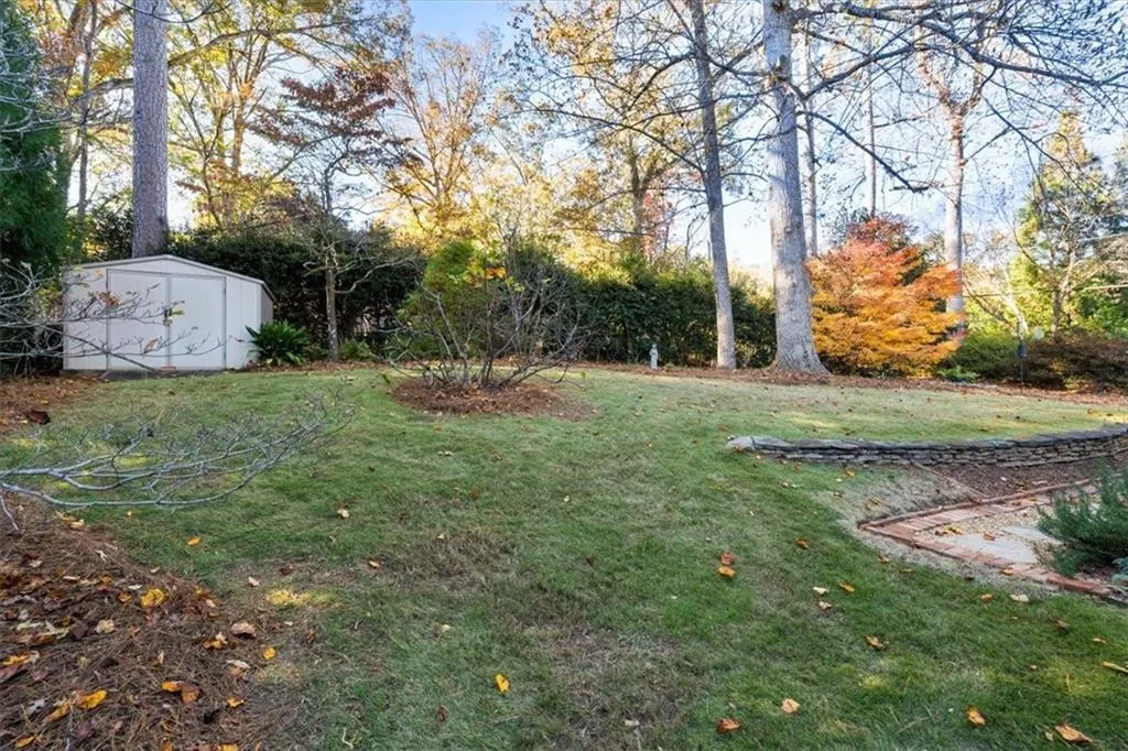 View of grassy yard featuring a storage shed