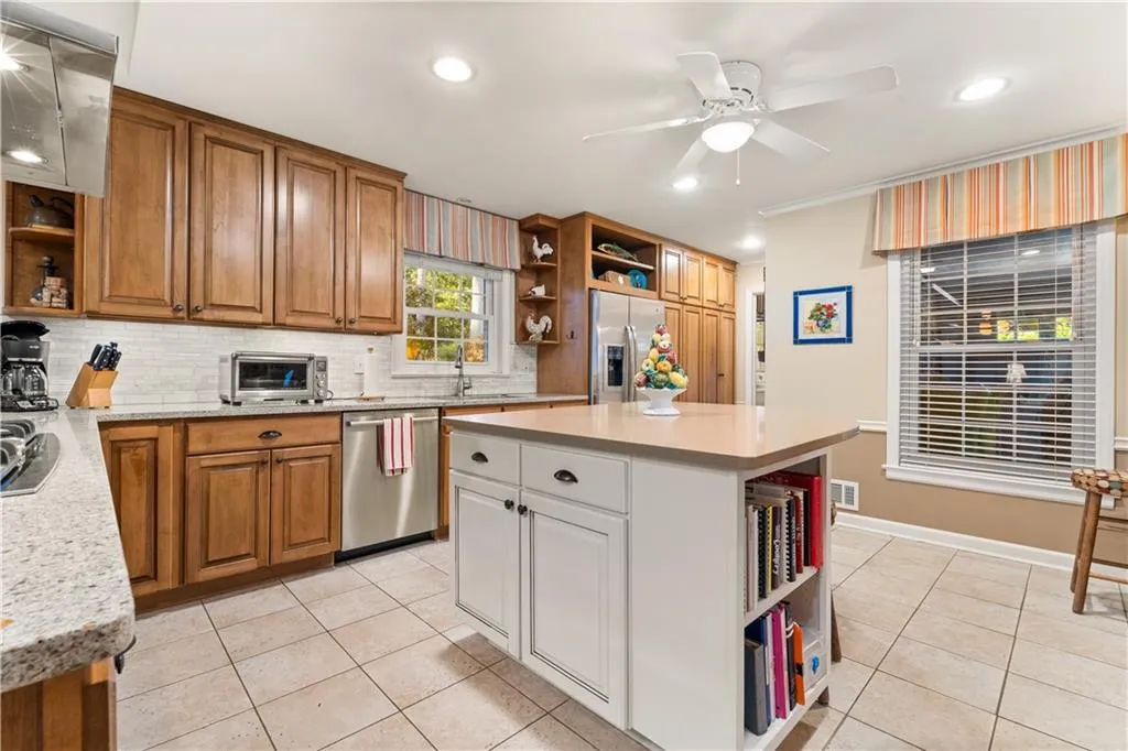 Kitchen featuring open shelves, light tile patterned flooring, white cabinetry, recessed lighting, and ornamental molding