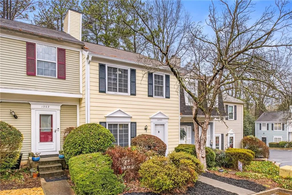 Colonial home featuring a chimney and entry steps