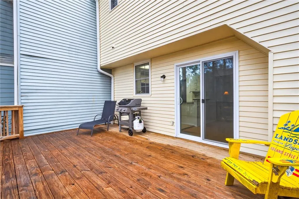 Wooden terrace featuring area for grilling