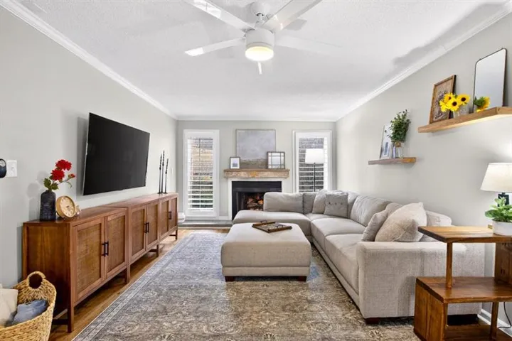 This home has 3 different living spaces!  The main living space has a gas fireplace, reclaimed wood mantle and plantation shutters. This is the perfect spot to sit back and relax, fireside, after a long day at work!