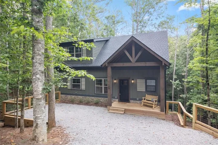 Charming cottage-style home featuring a covered front porch with exposed timber framing