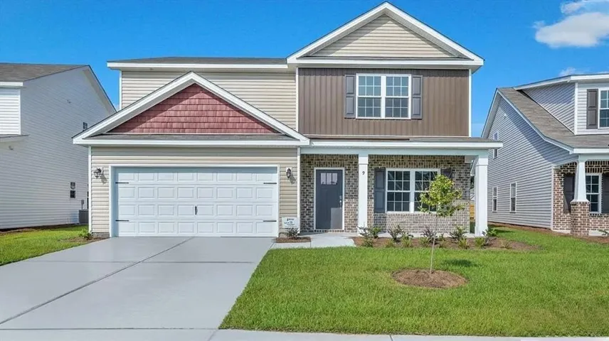 Two-story exterior with mixed siding, brick detailing, covered porch, and attached garage
